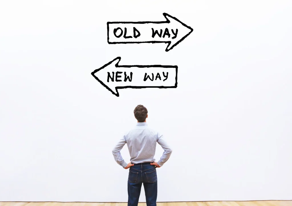 Person standing and choosing between an old way and a new way illustrated by arrows, symbolizing the shift to modern lead generation strategies.